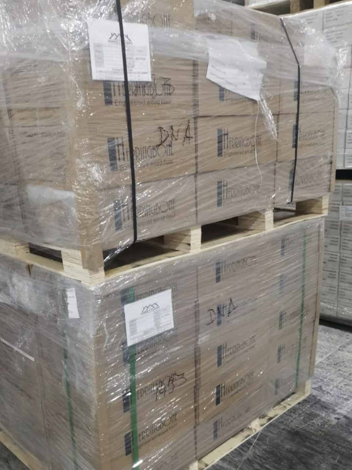 Herringbone flooring boxes stacked and labelled on a pallet